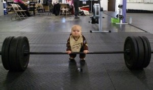 Cute baby trying to lift weights