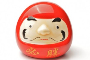 Daruma dolls are a depiction of Bodhidharma. He lost the use of his arms and legs after spending nine years meditating in a cave. The dolls are heavy on the bottom and bounce back when tipped over, so it has become a symbol of optimism, good fortune and strong determination. Usually daruma dolls are sold without the eyeballs painted in. People paint in one eye when they set out to do something and paint in the other one when they have achieved the goal.